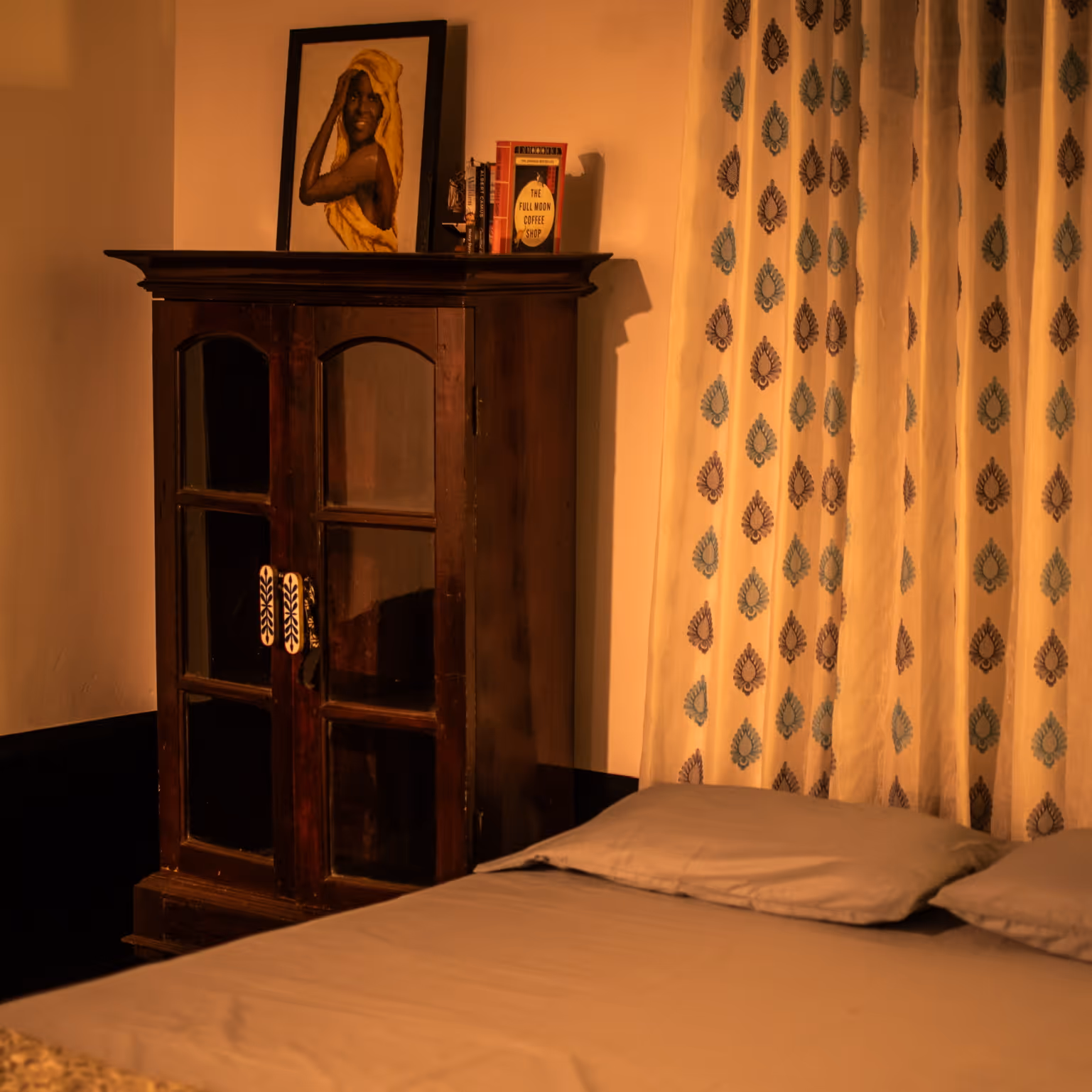 Picture of the guest room showcasing a cupboard and a bed